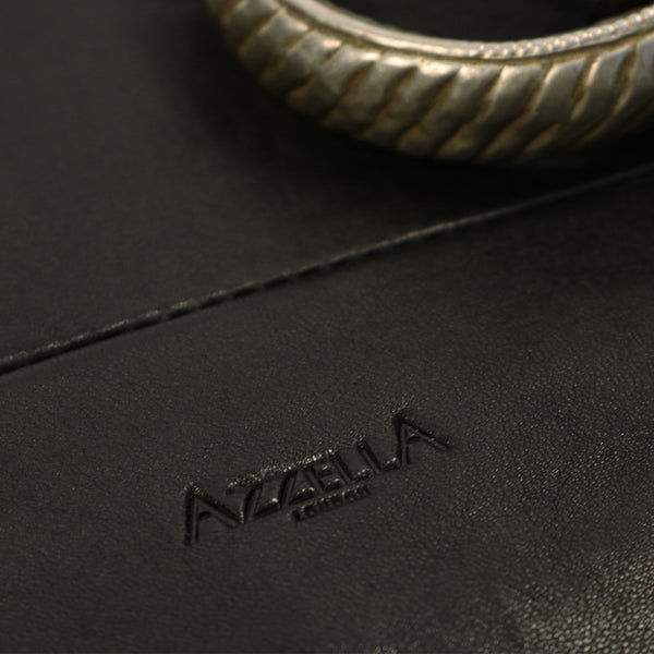 close up vintage bracelet and AzzellA logo on black leather