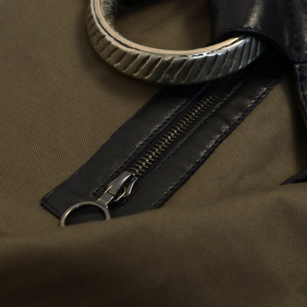 interior black leather bag with olive cotton lining zip detail and vintage tribal bracelet