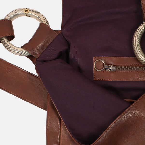 close up interior zip pocket handmade brown leather cross body shoulder bag . close up vintage tribal jewellery bracelet