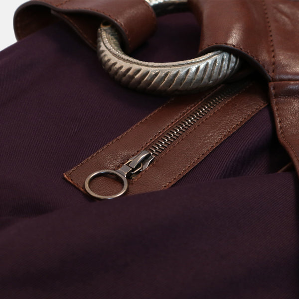close up interior zip pocket and tribal jewellery detail. handmade veg tan leather shoulder bag