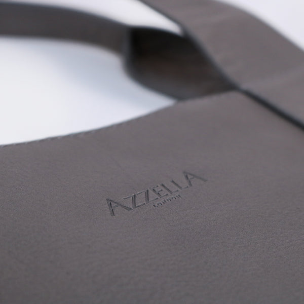 close up detail of azzella logo on italian leather grey handmade bag artisan 